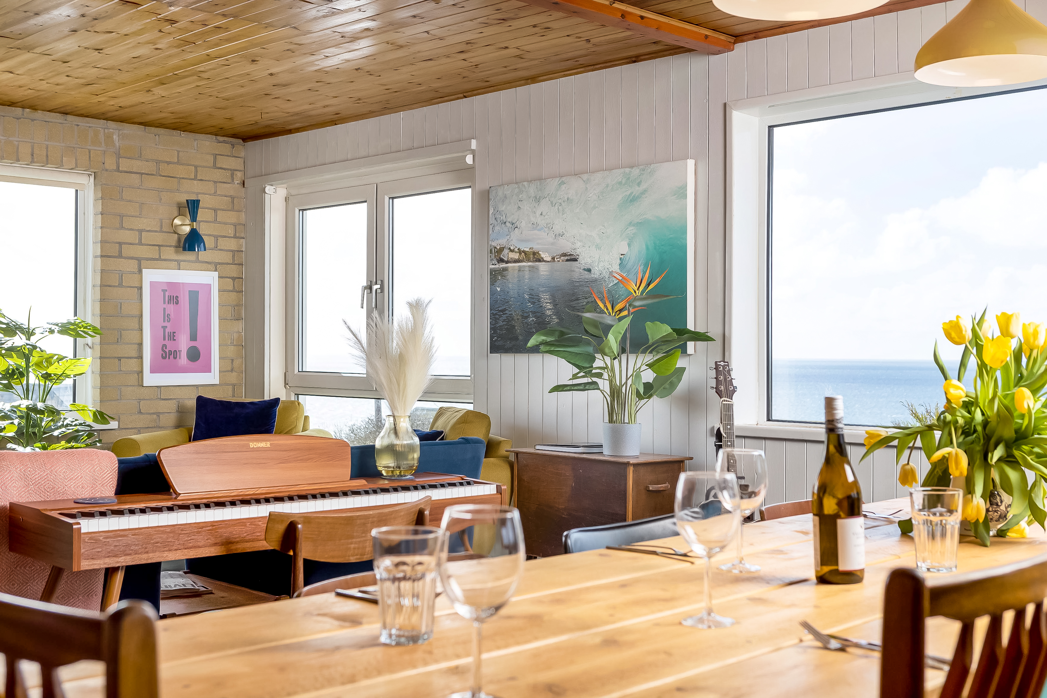Living room seating area with ocean panorama through large windows